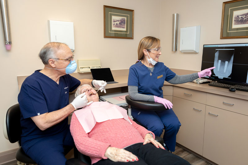 dr faiella performing dental procedure