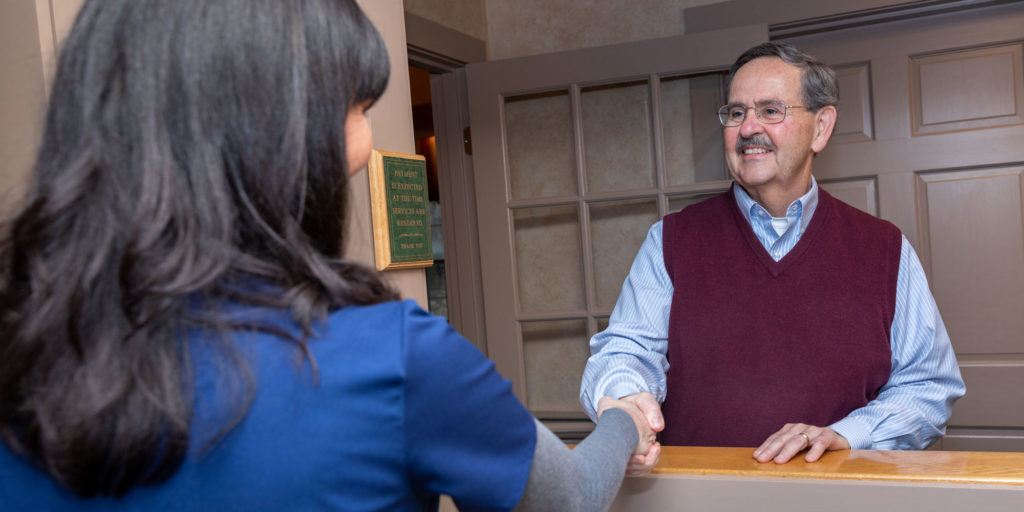 office manager welcoming dental patient